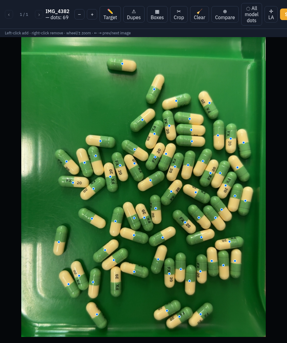 The dot editor over a real production photo: 69 capsules on a tray, one dot each
